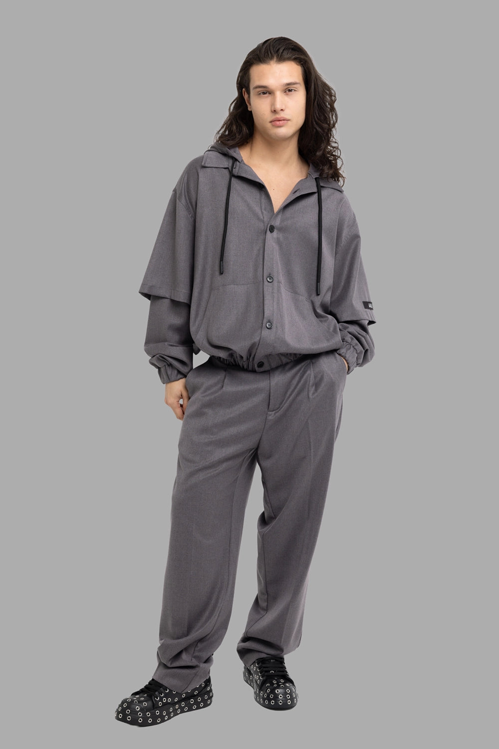 Gaëlle Paris men's hooded overshirt in black, on-model full length, button front and drawcord hem