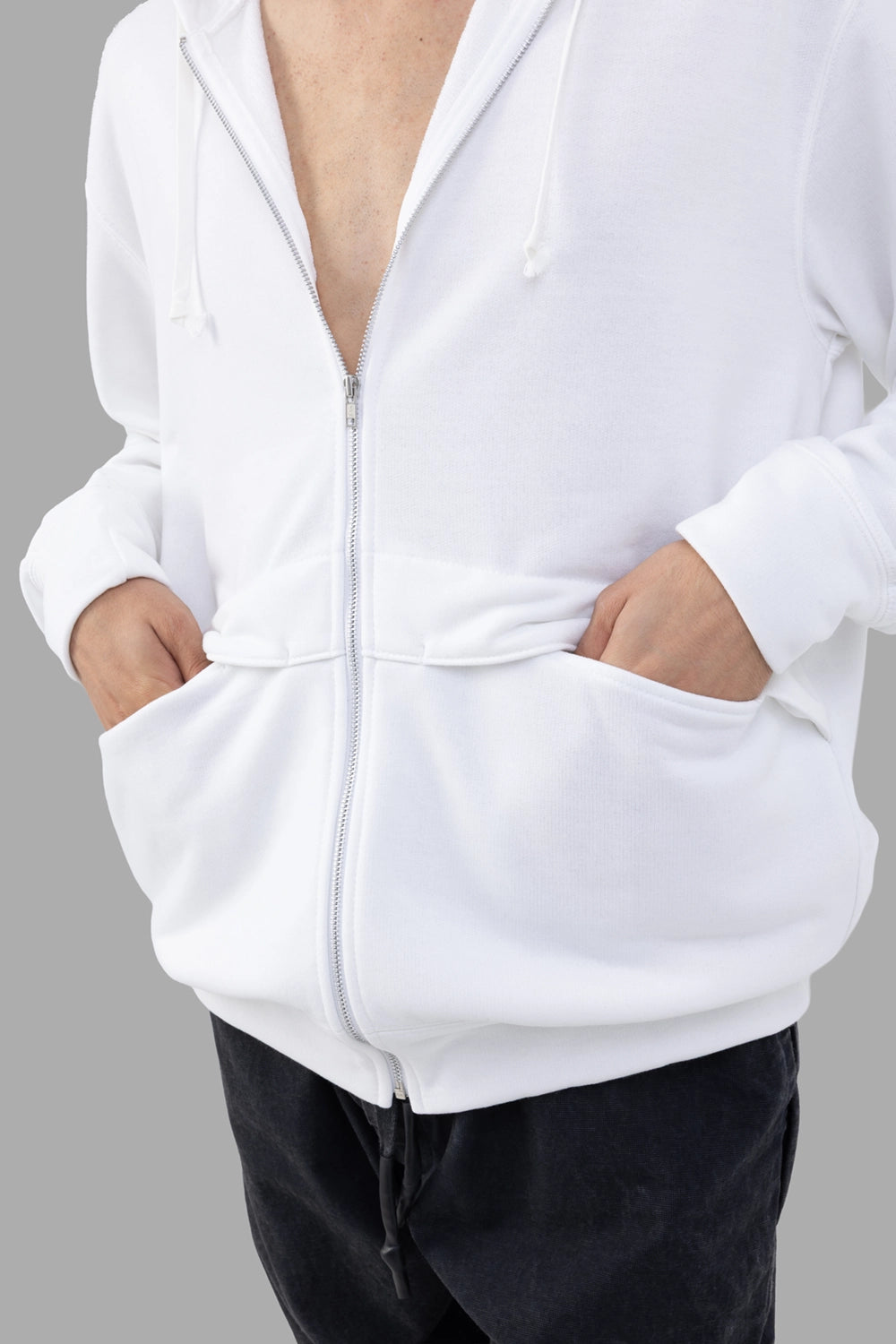 Comme des Garçons white hoodie, close-up of front kangaroo pockets and ribbed hem