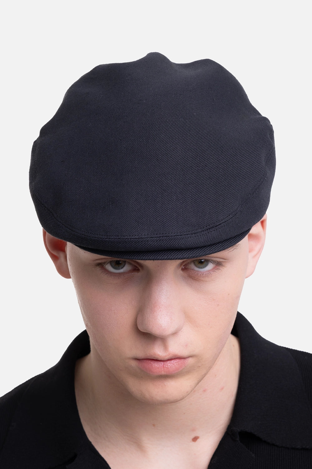 KIJIMA TAKAYUKI hunting cap in black, on-model close-up front view, low rounded crown and short brim