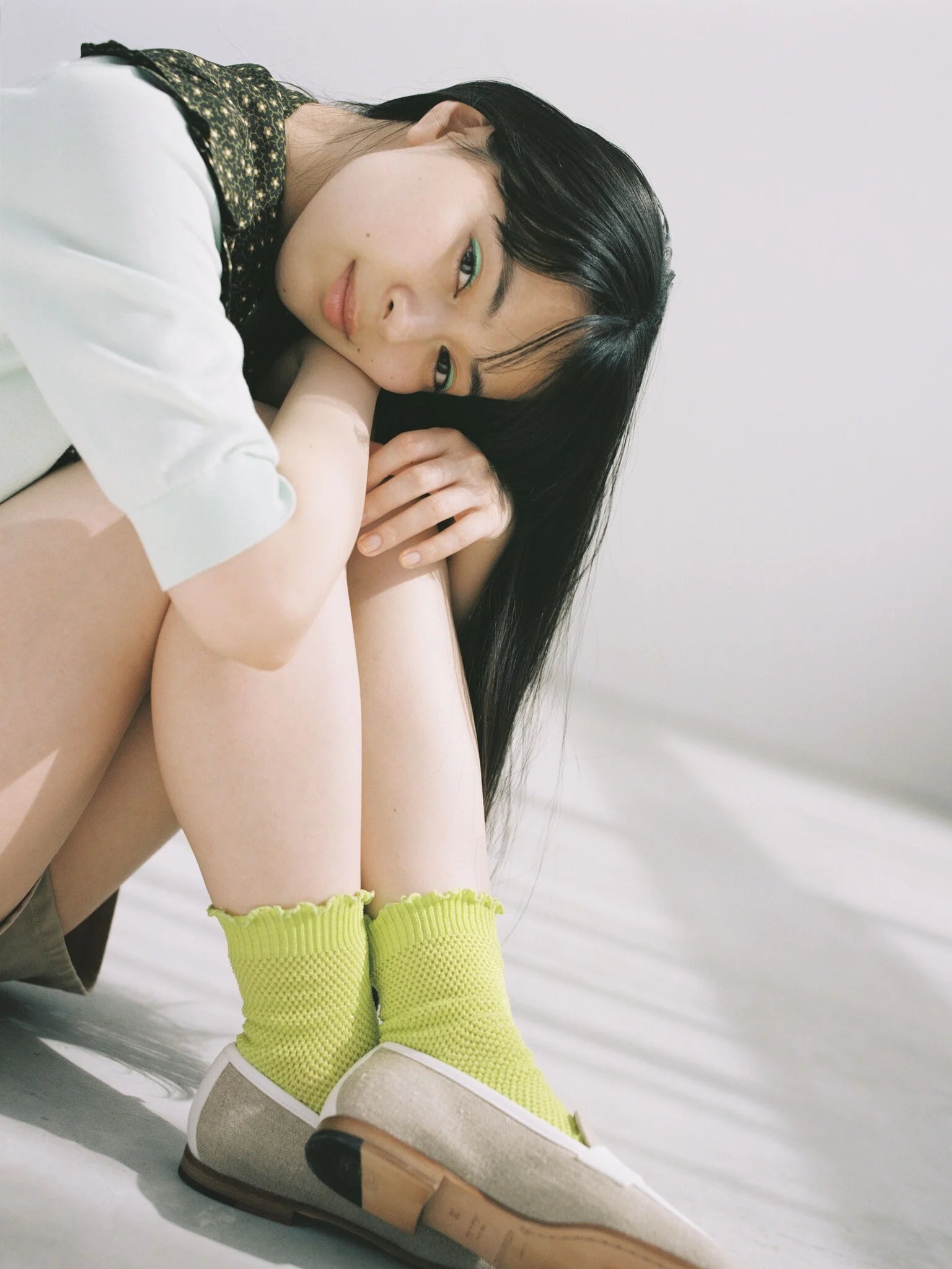 Tabio Merrow Top Mesh Low Crew Socks in vibrant lime, showcasing textured mesh and ruffled cuffs on a model's legs.