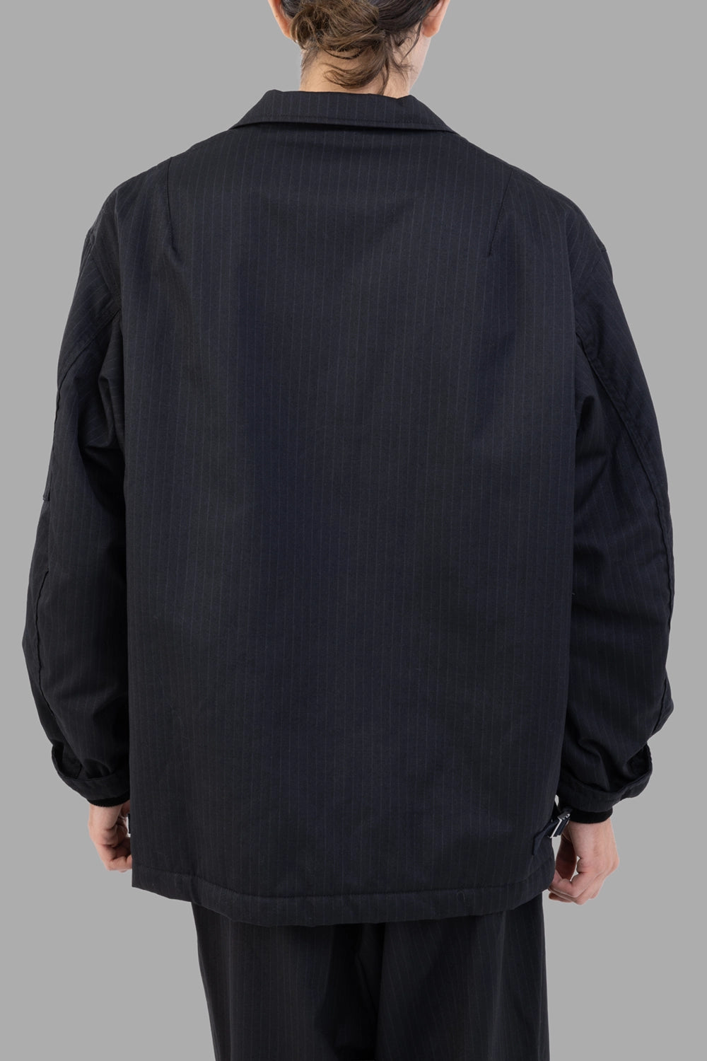 Junya Watanabe jacket in black pinstripe, back view, clean panel and relaxed shoulders