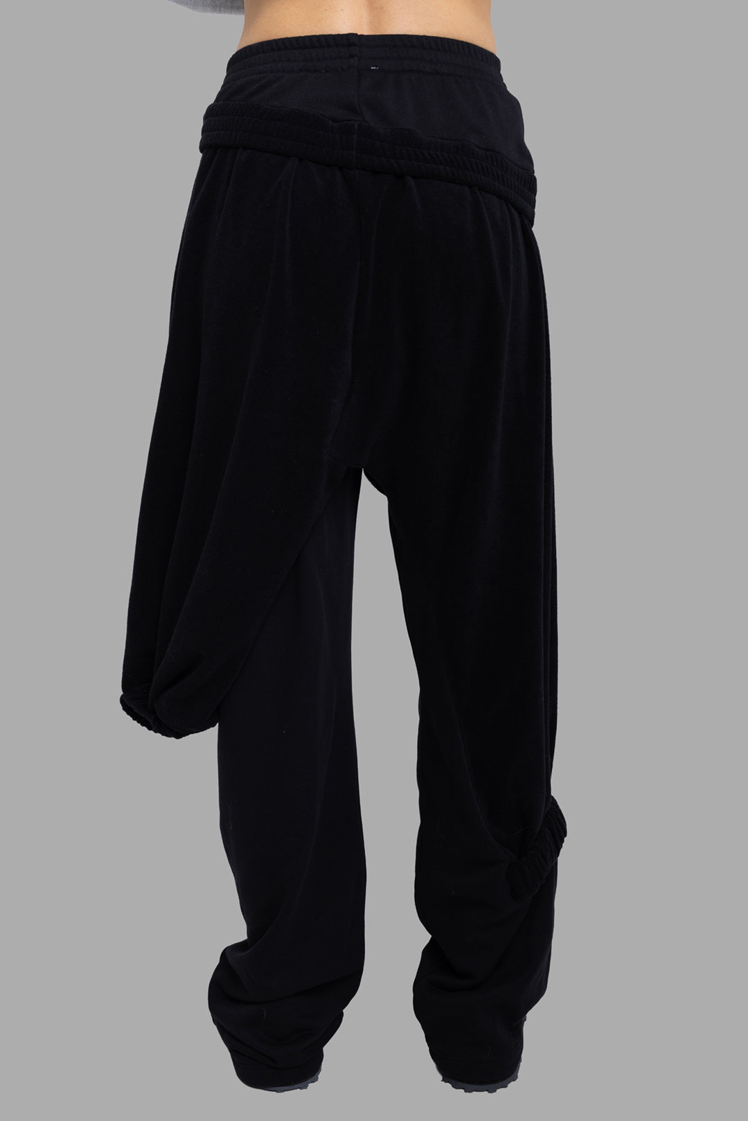 Natasha Zinko women joggers in black, back view, asymmetric overlay leg and elasticated waistband