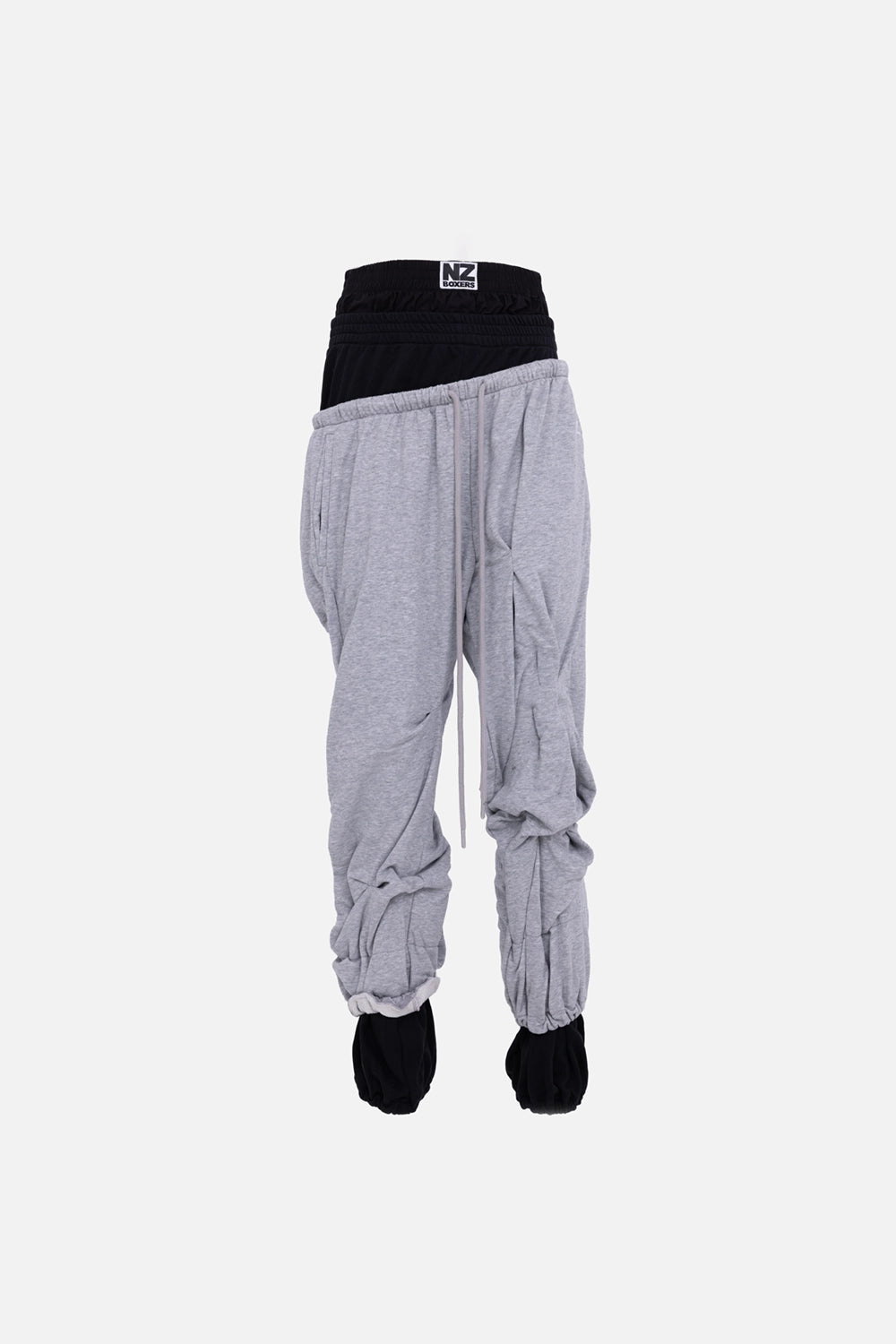 Natasha Zinko women’s joggers in black/grey, front view, low-slung layered waist and elastic cuffs.