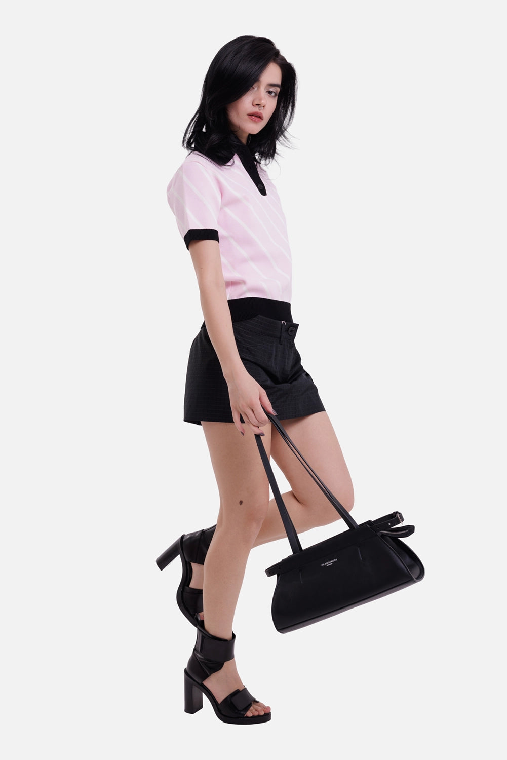 MSGM women's knit polo in pink, white and black, full-length model view with diagonal stripes and contrast ribbed trims
