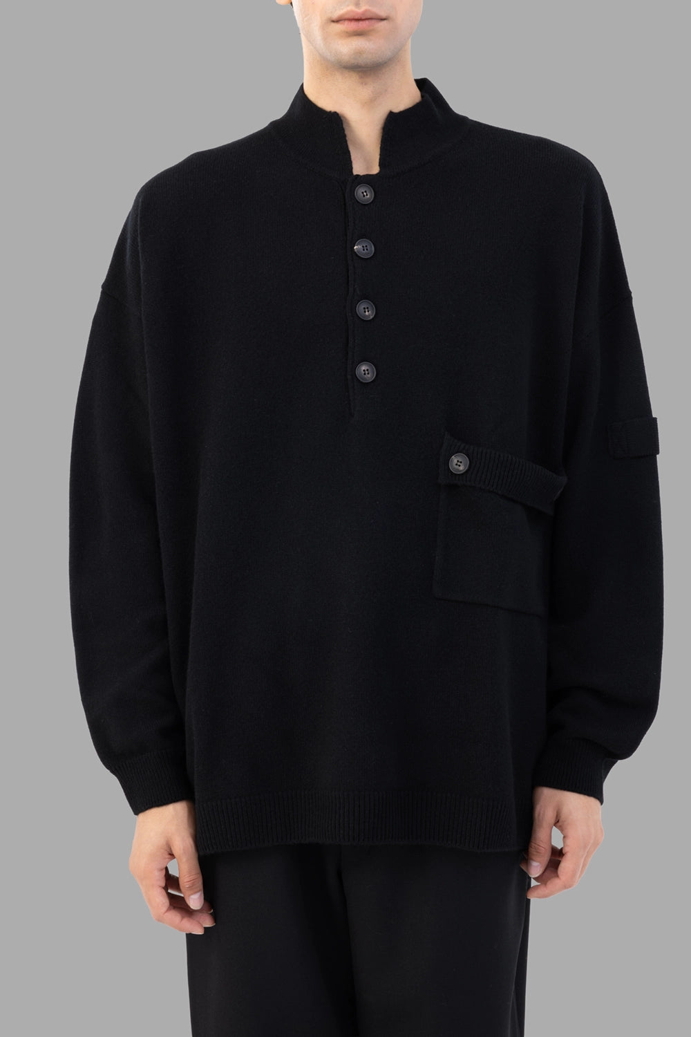 AION knit pullover in black, front view, stand collar with four-button placket