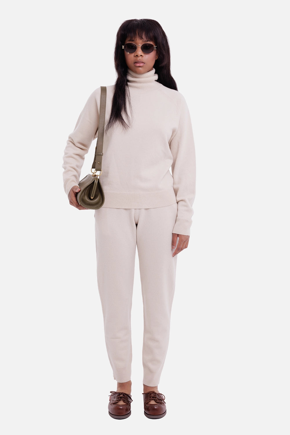 Women’s knit trousers in stucco, full-length view with tapered legs and ribbed ankle cuffs