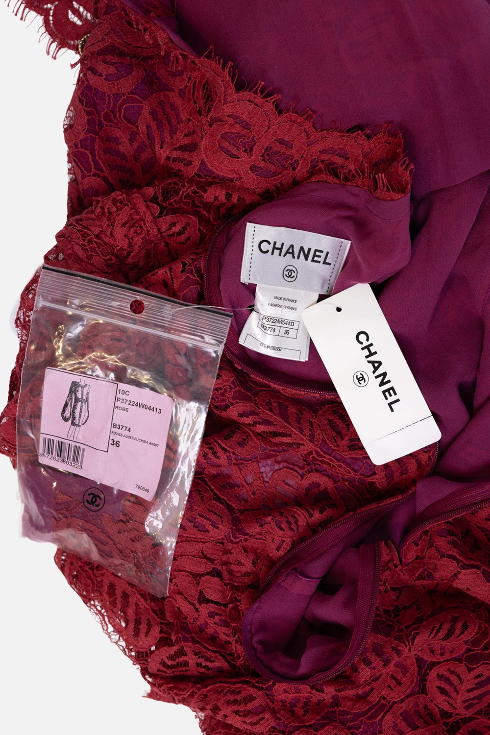 Pre-owned Chanel women's lace dress in burgundy, label and hang tag view, spare button bag shown.