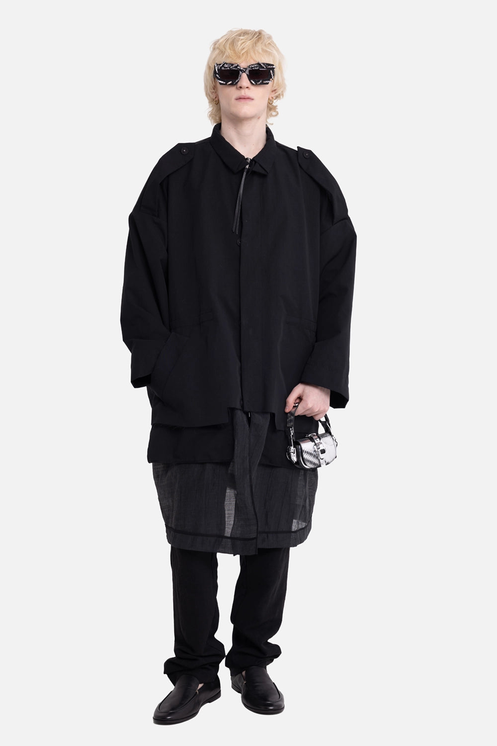 Greg Lauren men's coat in black, on-model full-length, buttoned shoulder tabs and sheer lower panel