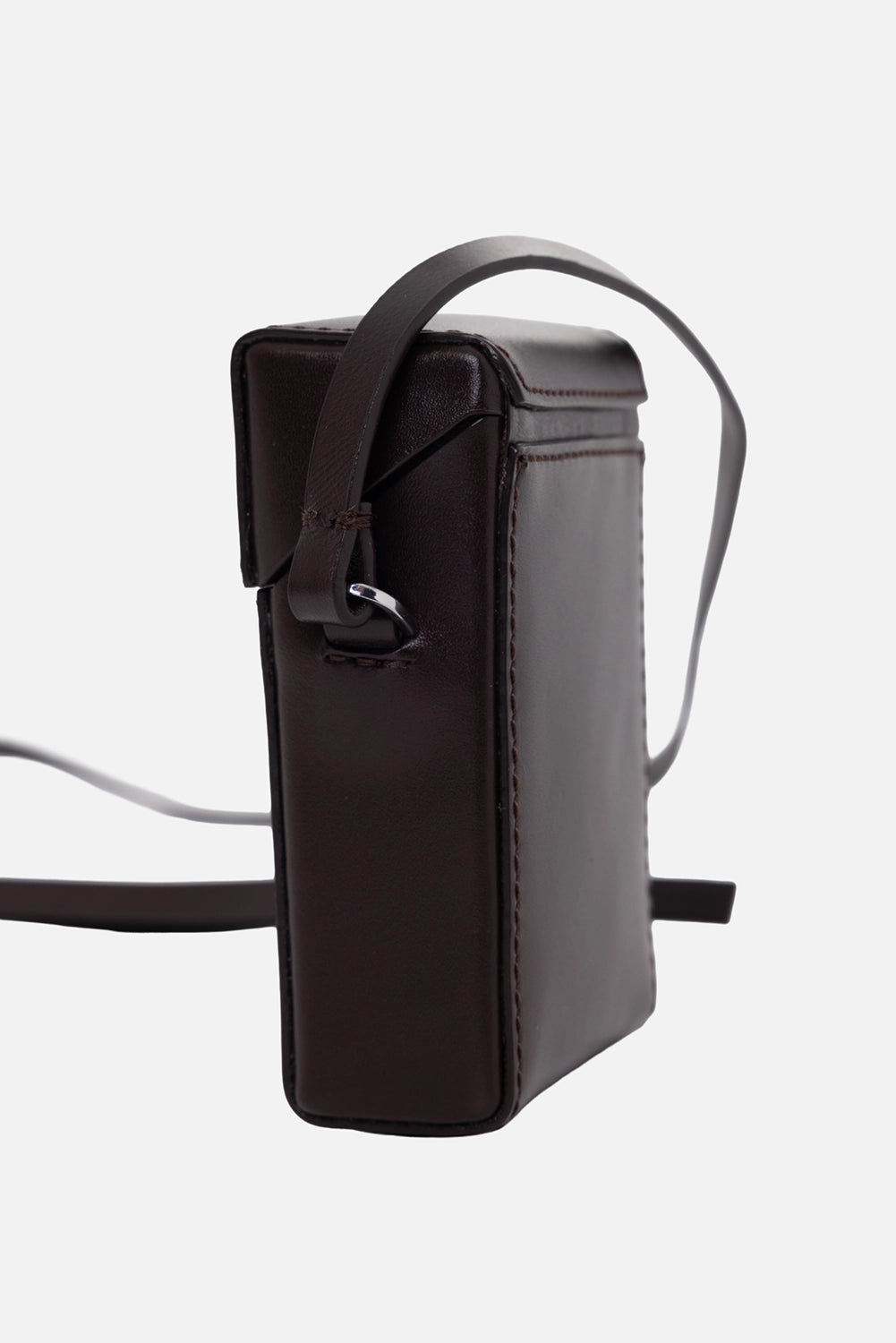 Helmut Lang leather case in mahogany, side view, silver D-ring strap anchor and structured profile