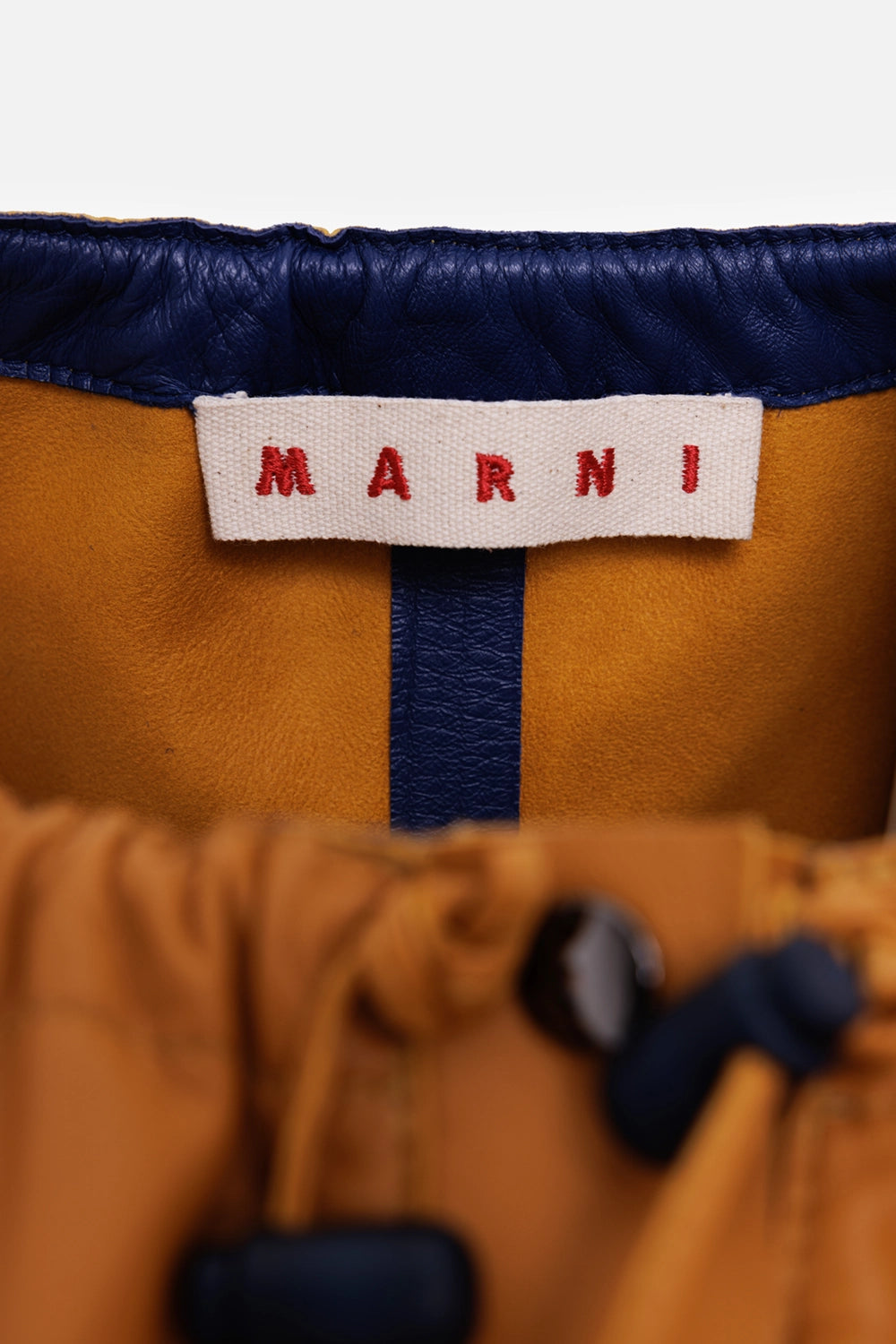 Marni women's leather coat dress in ochre, label view, navy leather trim and gathered neckline