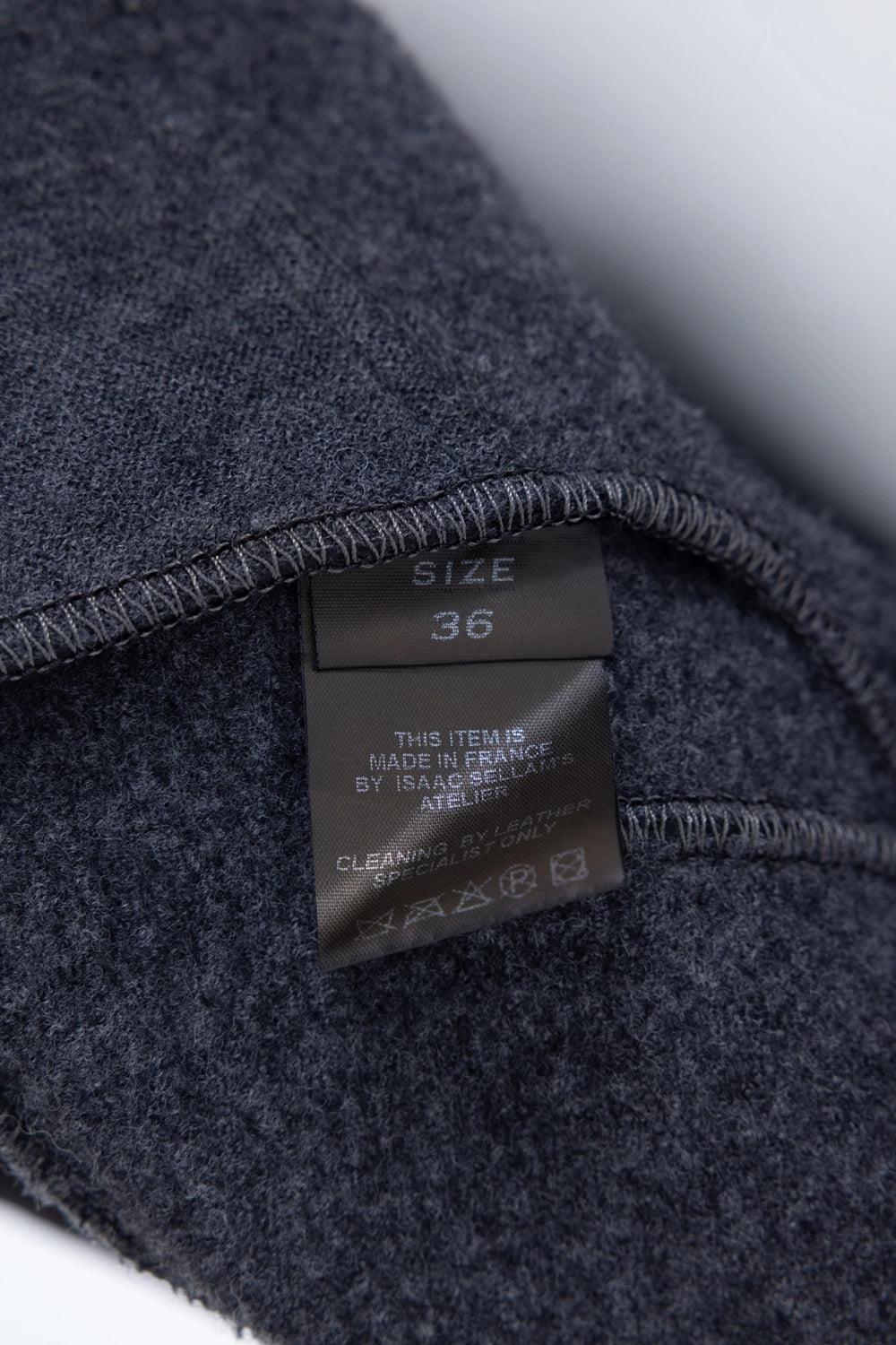 Pre-owned Isaac Sellam women's leather jacket in black, interior label view, size tag and care instructions