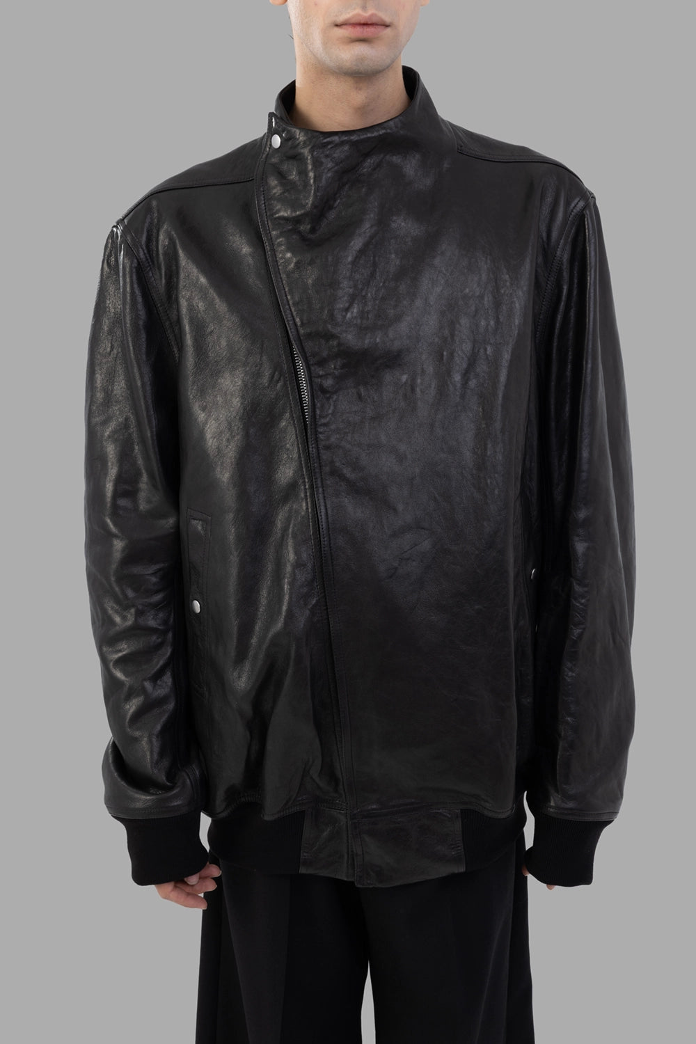 Rick Owens leather flight jacket in black, front close view, snap neck tab and ribbed cuffs