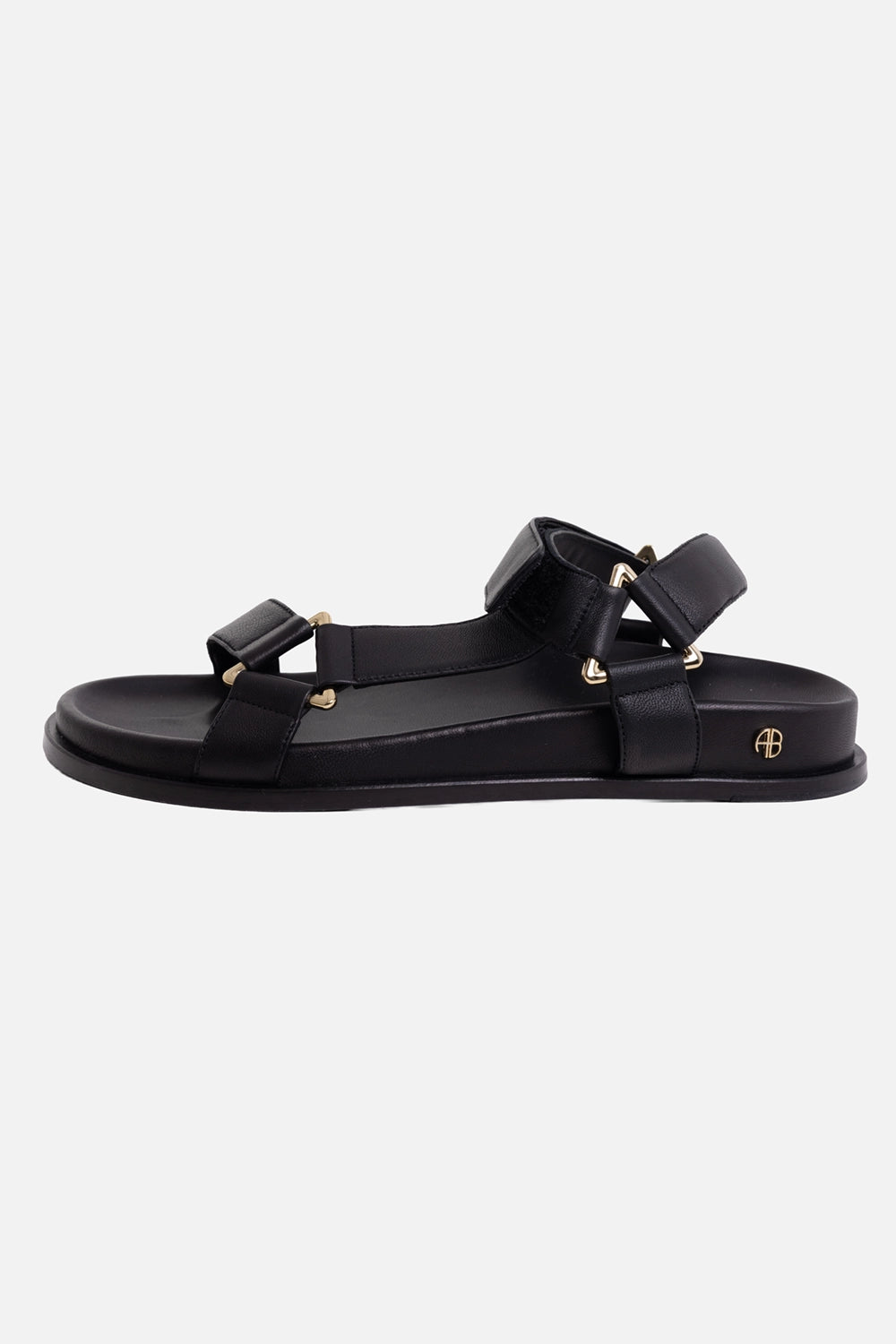 Anine Bing women's leather sandals in black, side view with padded straps, gold-tone rings and AB heel logo
