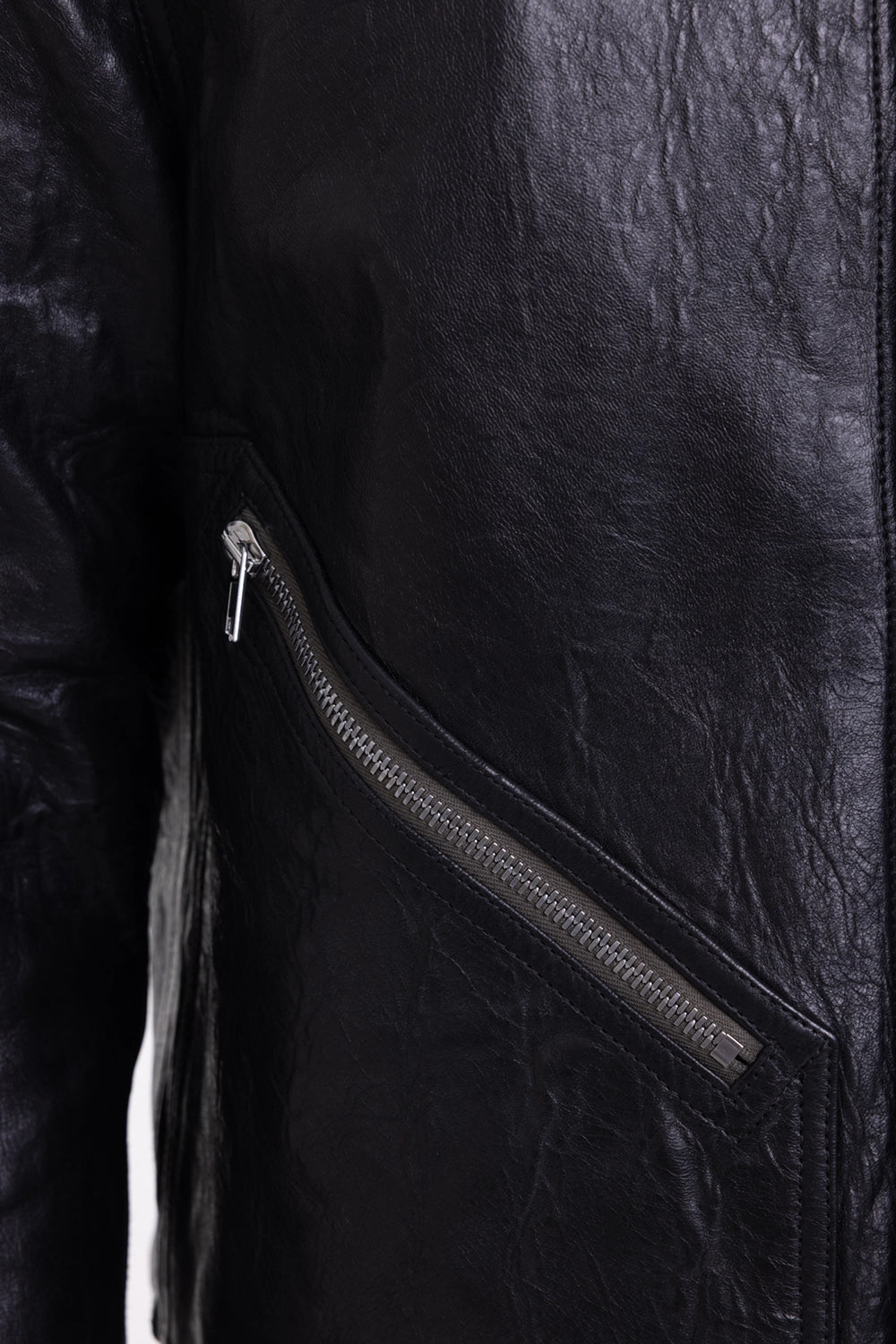 Rick Owens men's leather shirt jacket in black, zipper-detail view, silver diagonal zip and crinkled leather