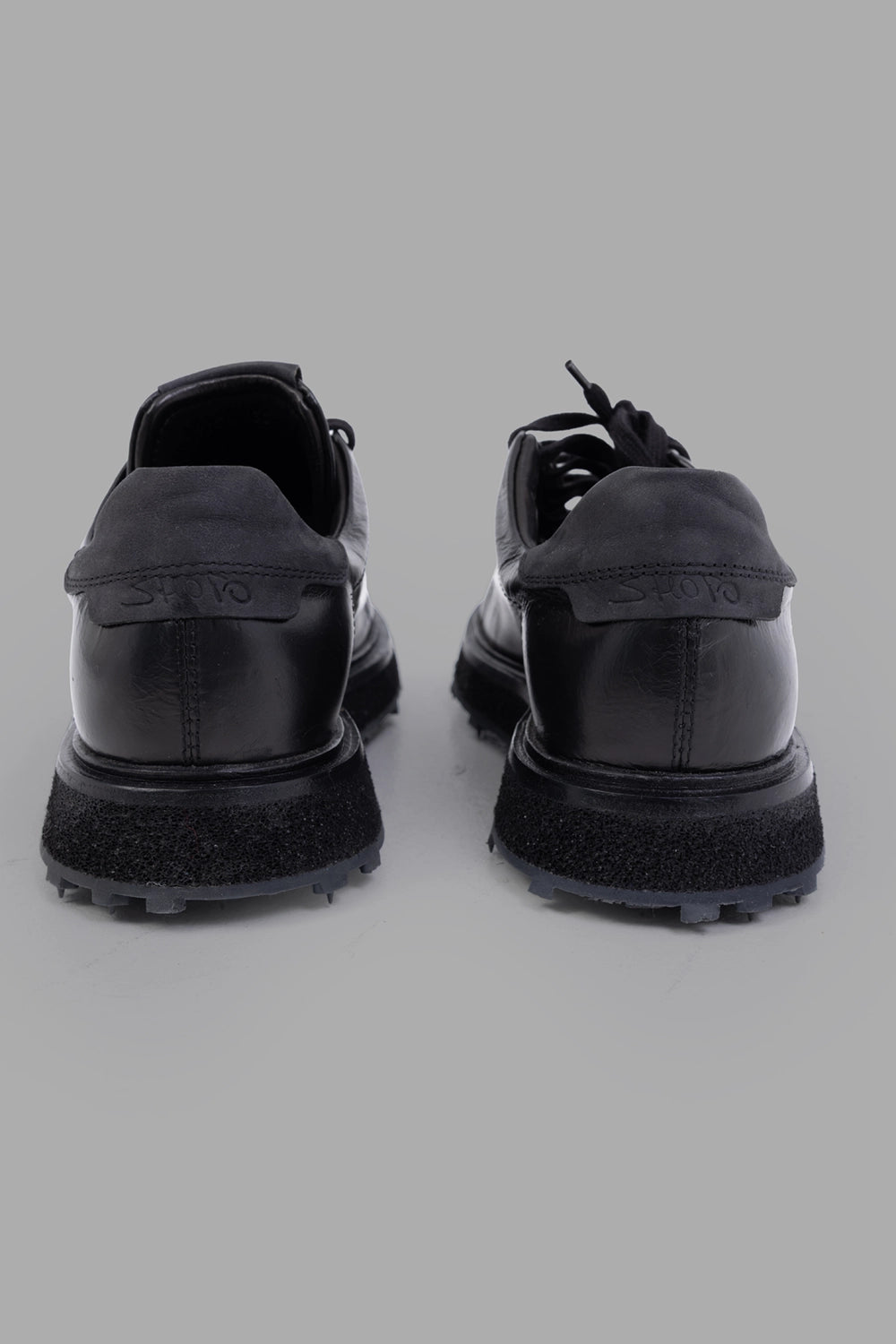 Shoto unisex leather low-top sneakers in black, back view, matte heel tab and layered midsole