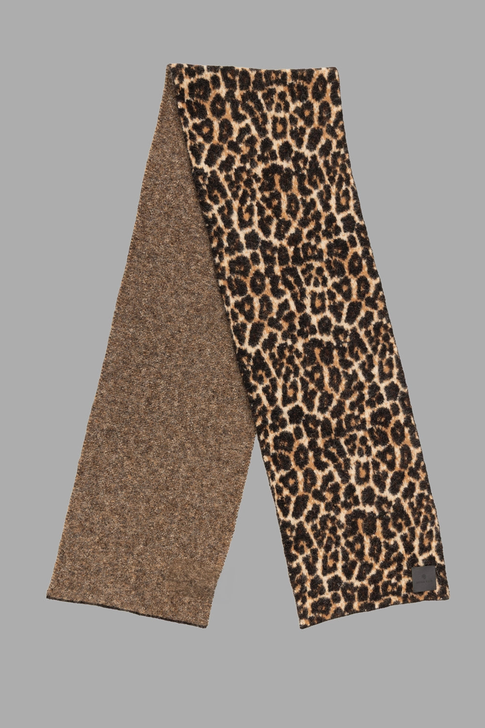 ANINE BING women leopard scarf in black and brown, 3/4 view, long rectangular shape with logo patch