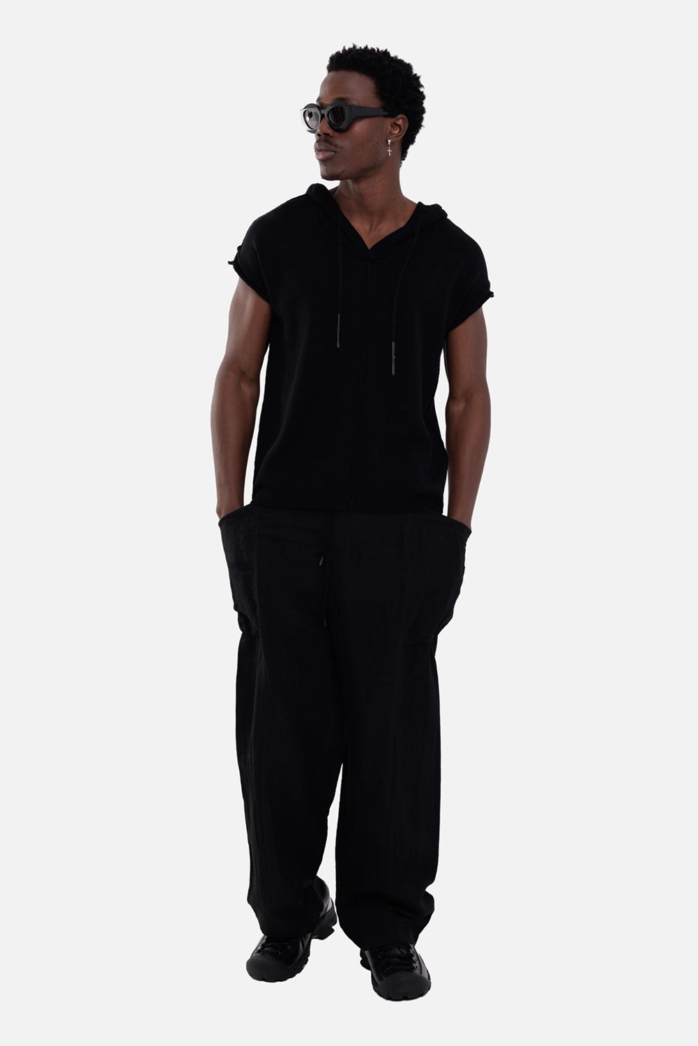 Comme des Garçons Homme men's cargo trousers in black, on-model full-length view, oversized side pockets