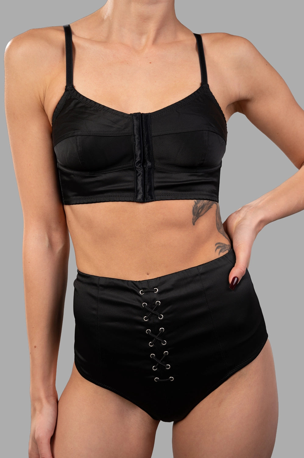 Sehnsucht Atelier lingerie set in black, front view of bralette with central closure and adjustable straps