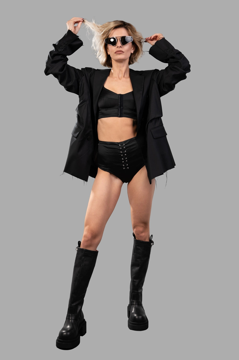 Sehnsucht Atelier lingerie set in black, on-model full length with front lace-up briefs and front-closure bralette