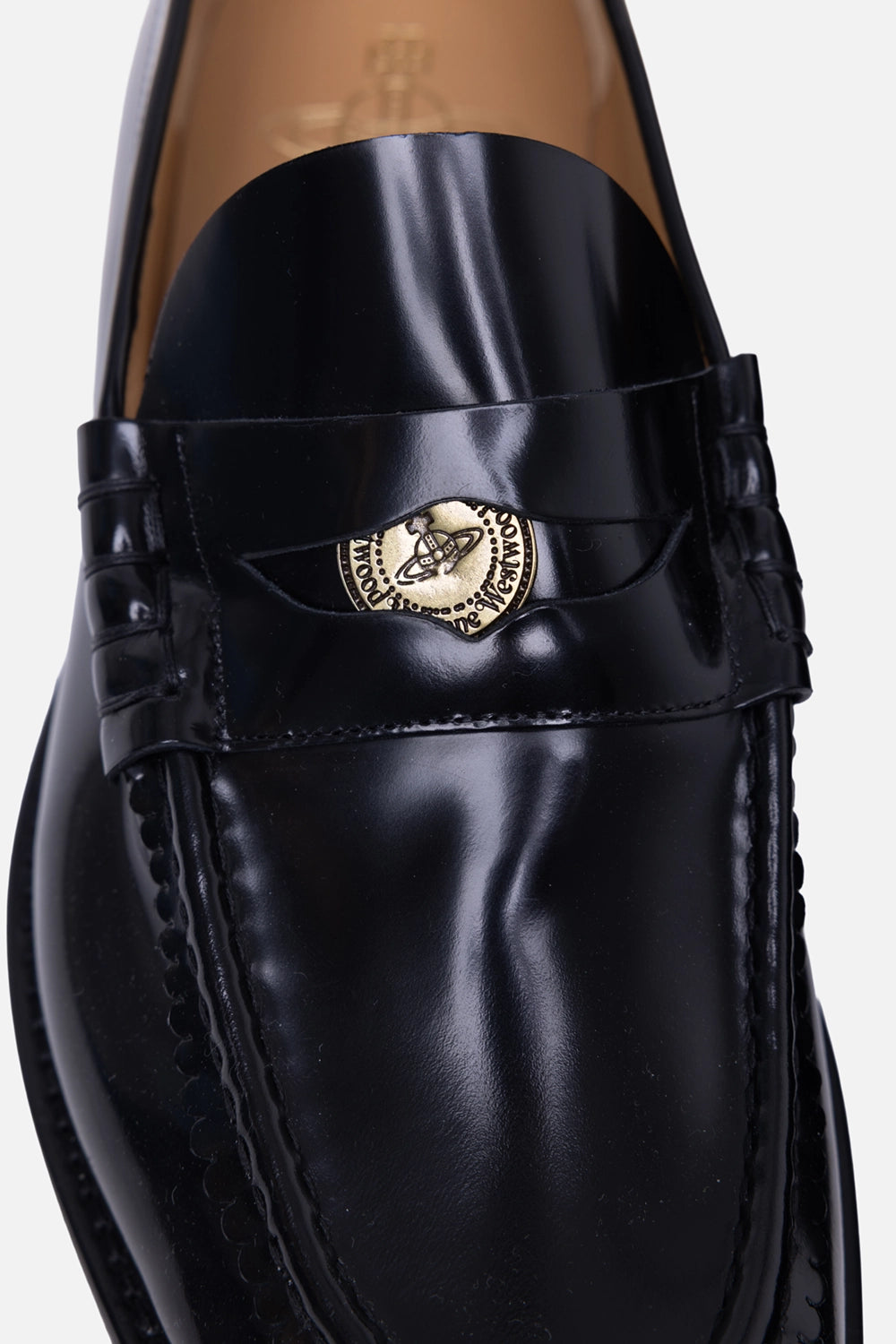 Vivienne Westwood men’s loafers in black, hardware close-up, orb-engraved coin detail on penny strap
