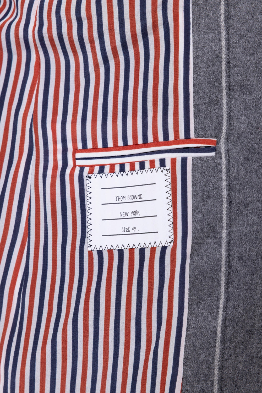 Pre-owned Thom Browne women's long blazer in grey, interior view, tricolour striped lining with name tag patch
