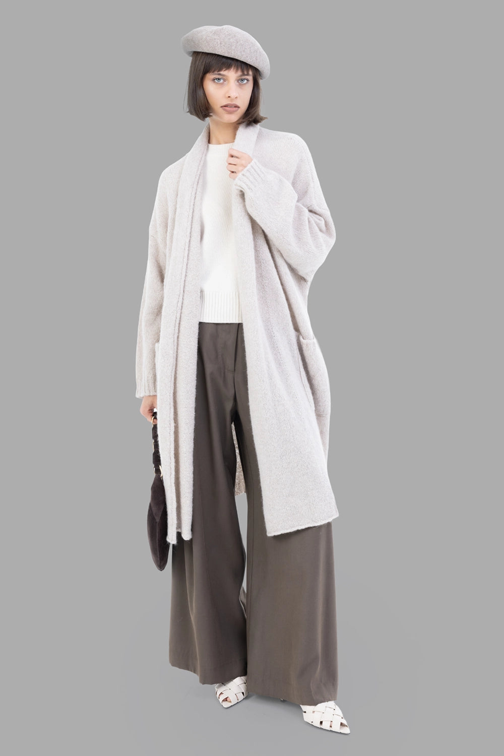 GentryPortofino women's long cardigan in Stucco, full-length on model, belted shawl collar and patch pockets.