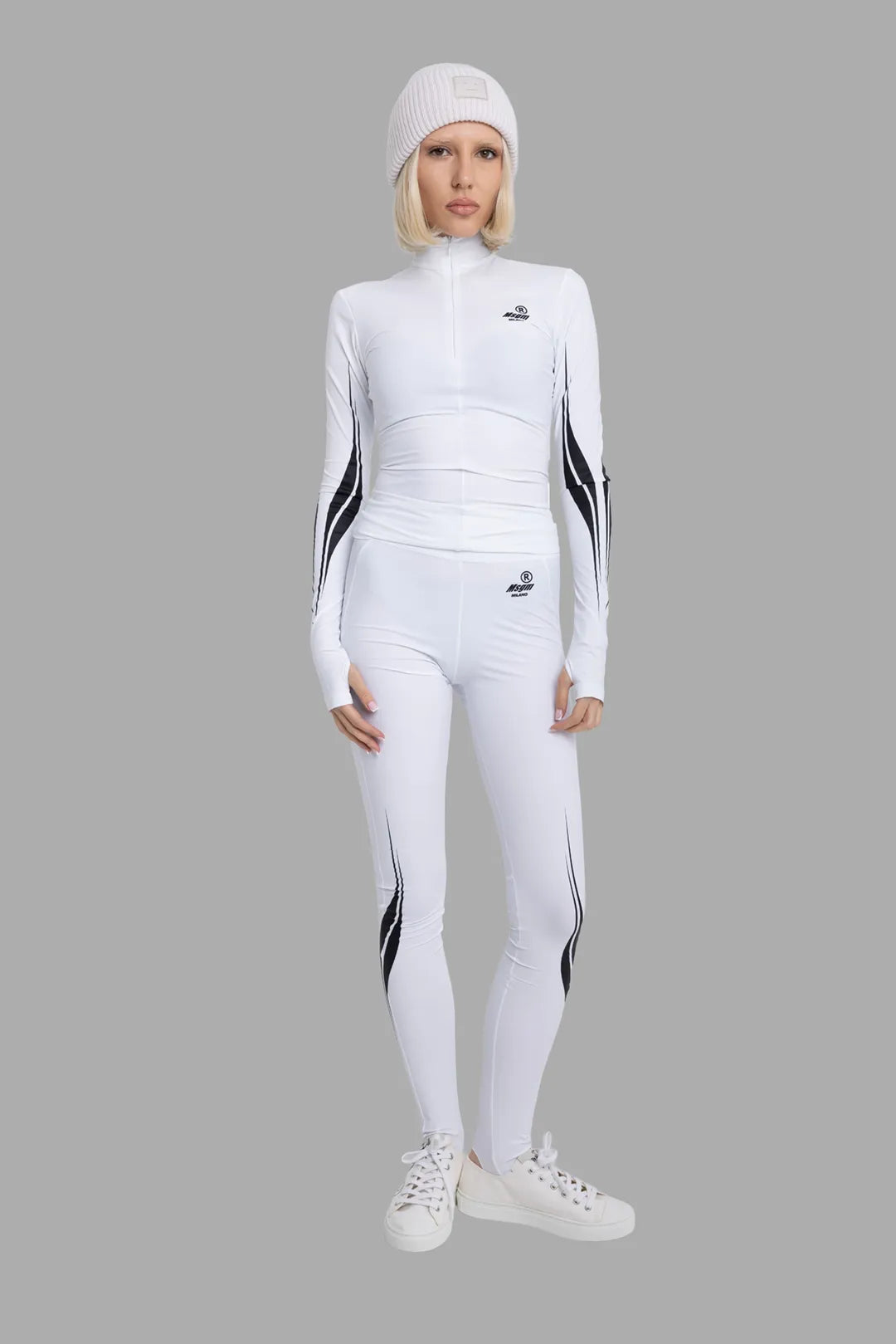 MSGM women's white lycra top, on-model full length, black race graphics down sleeves with thumbhole cuffs.