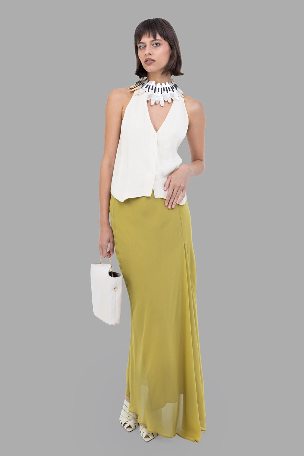 GentryPortofino women's georgette maxi skirt in Oliva, full-length on model, wide rib-knit waistband, fluid semi-sheer drape.