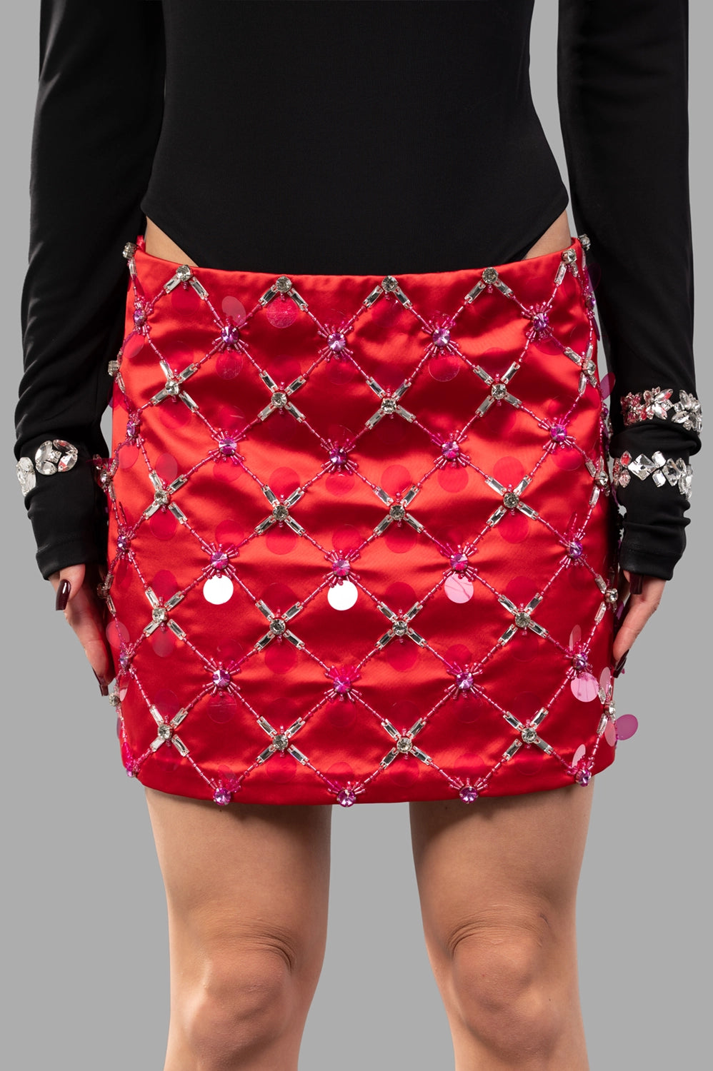 front close-up of red satin micro skirt with crystal lattice beading and sequins
