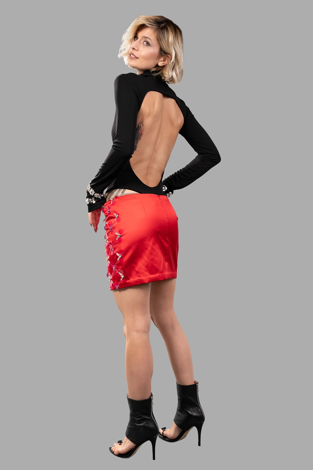 red satin micro skirt with crystal lattice embellishment, full-length on model