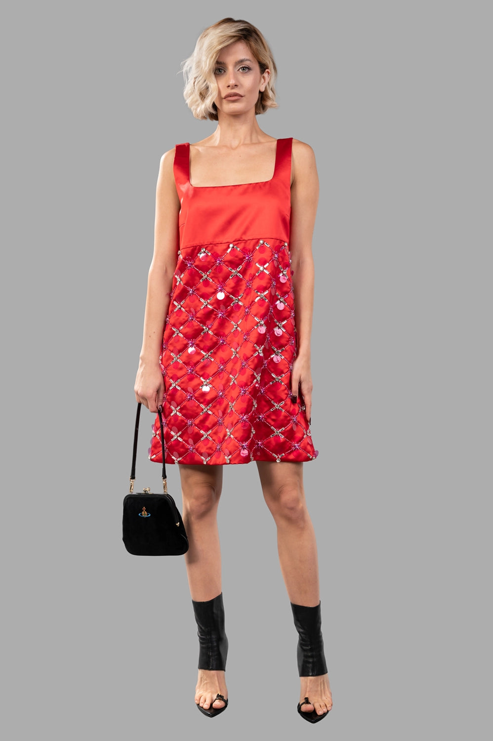 Full-length view of red duchesse high-waist mini dress with square neckline and embellished skirt.