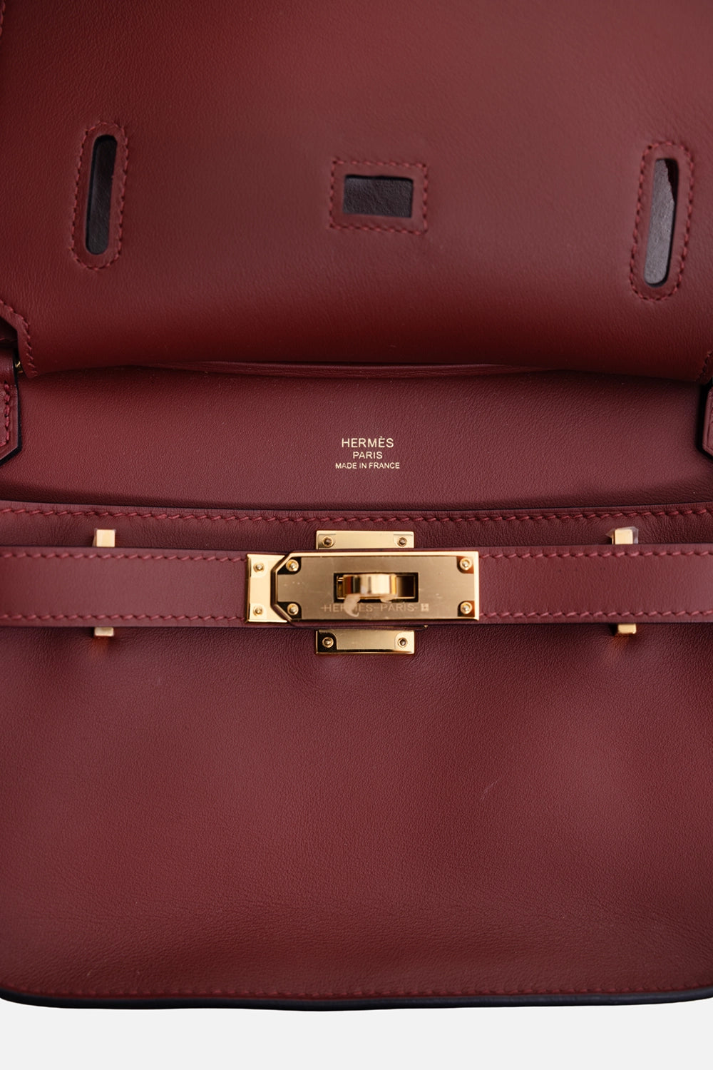 Pre-owned Hermès women's mini Jypsière bag in Rouge H, hardware close-up, gold turn-lock plate and Made in France stamp