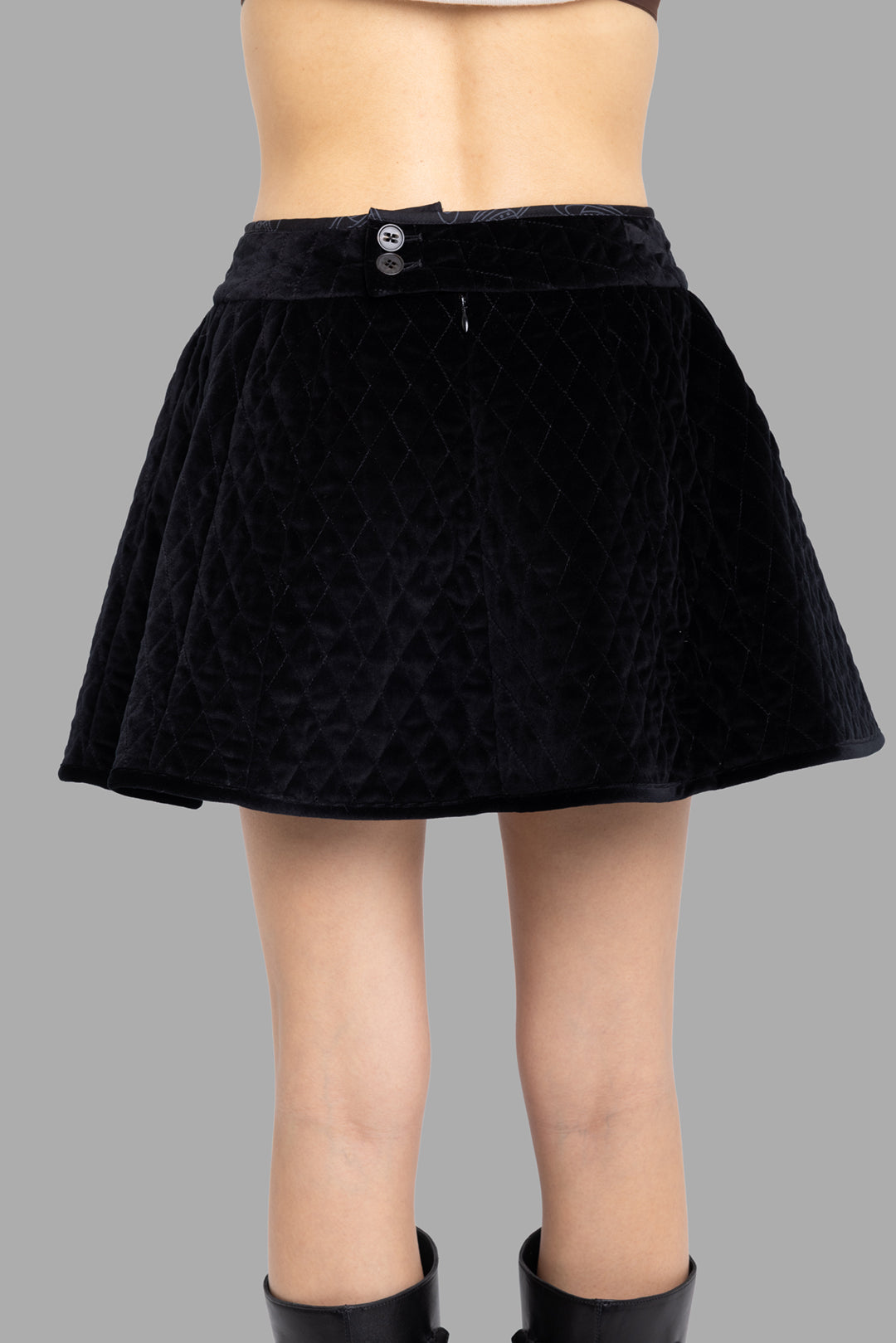 Vivienne Westwood women's black quilted velvet mini skirt, back view, elasticated waistband and soft flare.