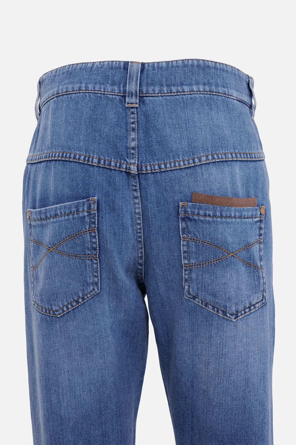 Brunello Cucinelli women's straight-leg jeans in blue, back pocket detail with brown tab and curved stitching