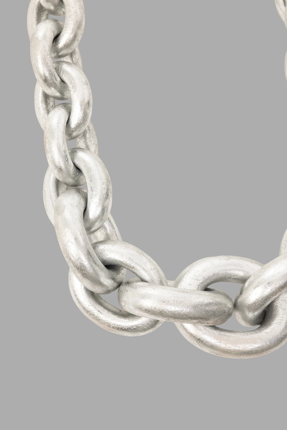 Monies women chain necklace in silver, hardware close-up, large central ring and interlocking links.