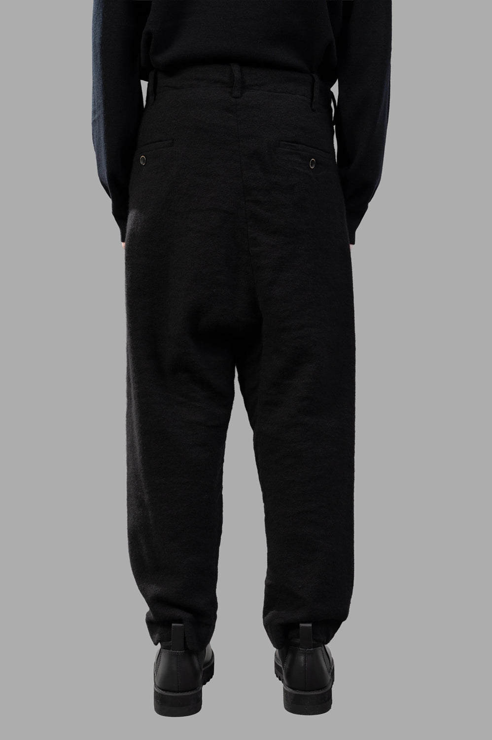 UMA WANG pants in black, back view, two buttoned welt pockets and belt loops