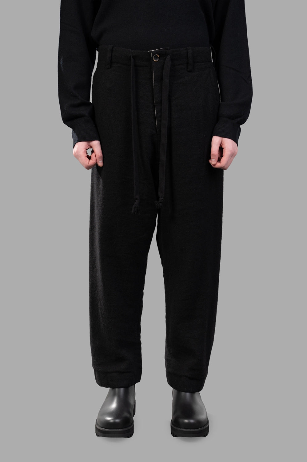 UMA WANG pants in black, front view, drawstring waist and front button detail