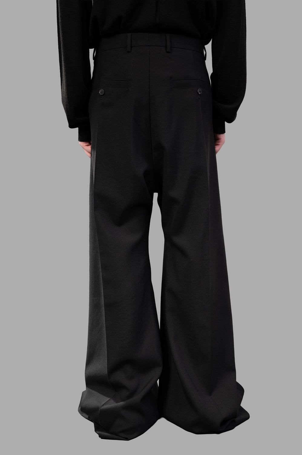 Rick Owens wide-leg pants in black wool‑blend, back view, creased legs and belt loops