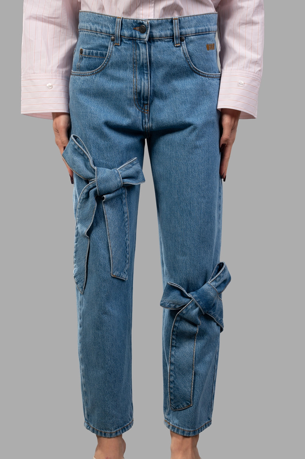 MSGM pants in blue washed denim, front view, five pockets and belt loops visible