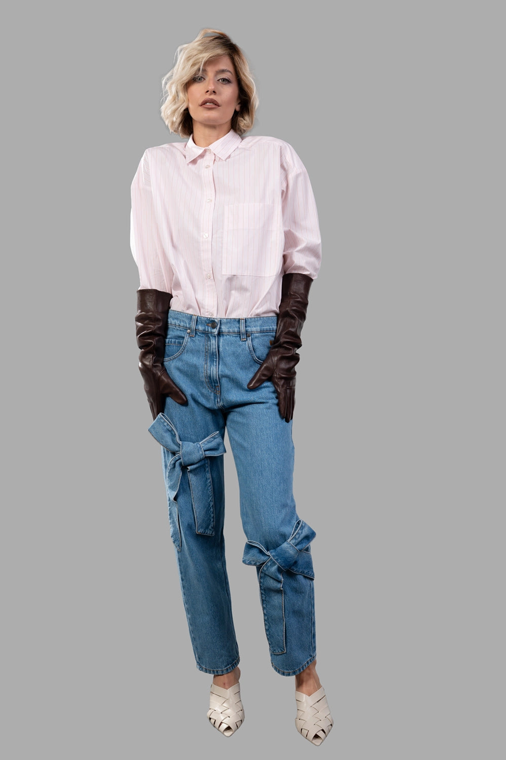 MSGM pants in blue washed denim, on‑model full length, stonewashed texture and logo embroidery on side