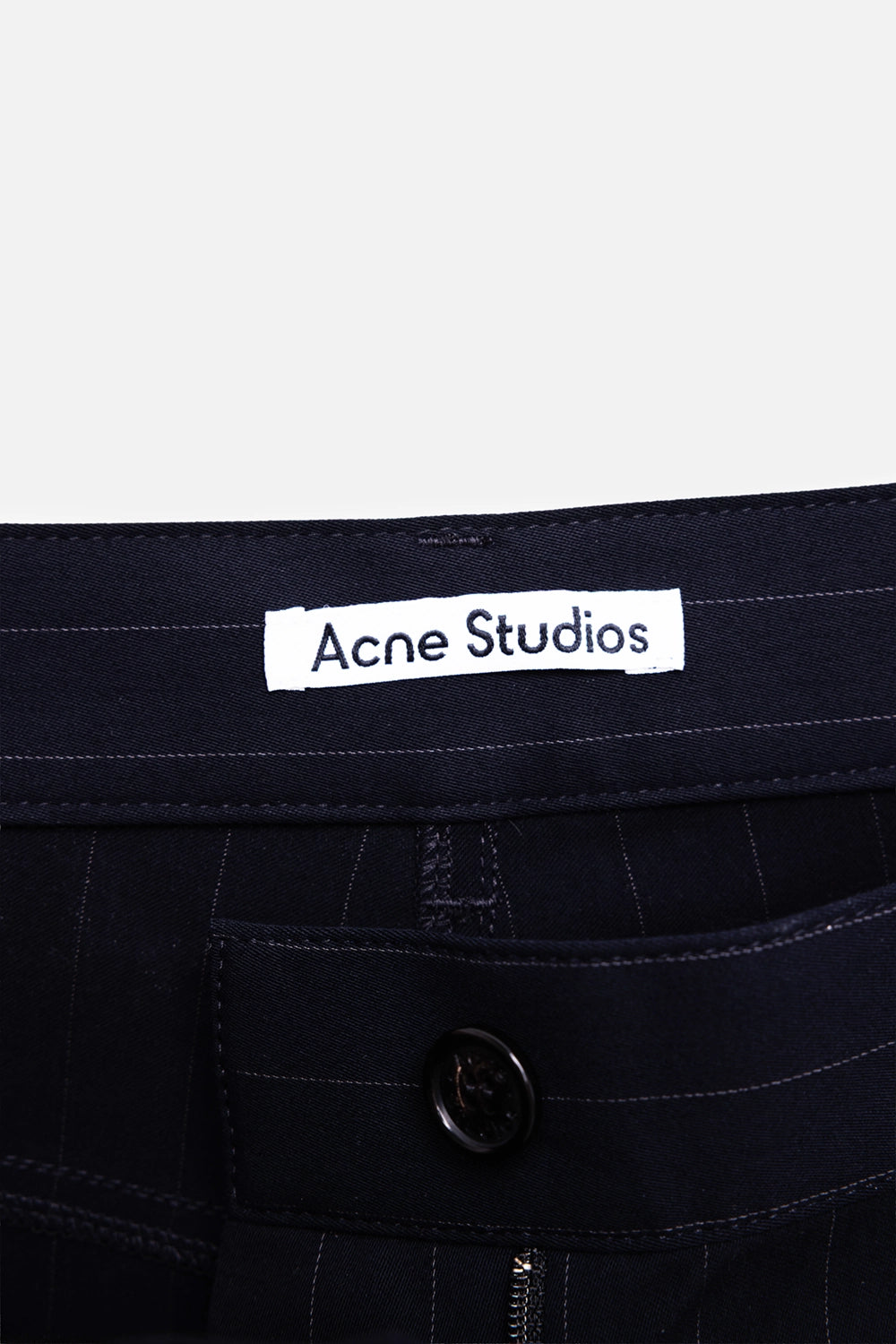 Acne Studios women's pinstripe trousers in navy, label detail with buttoned waistband and zip fly
