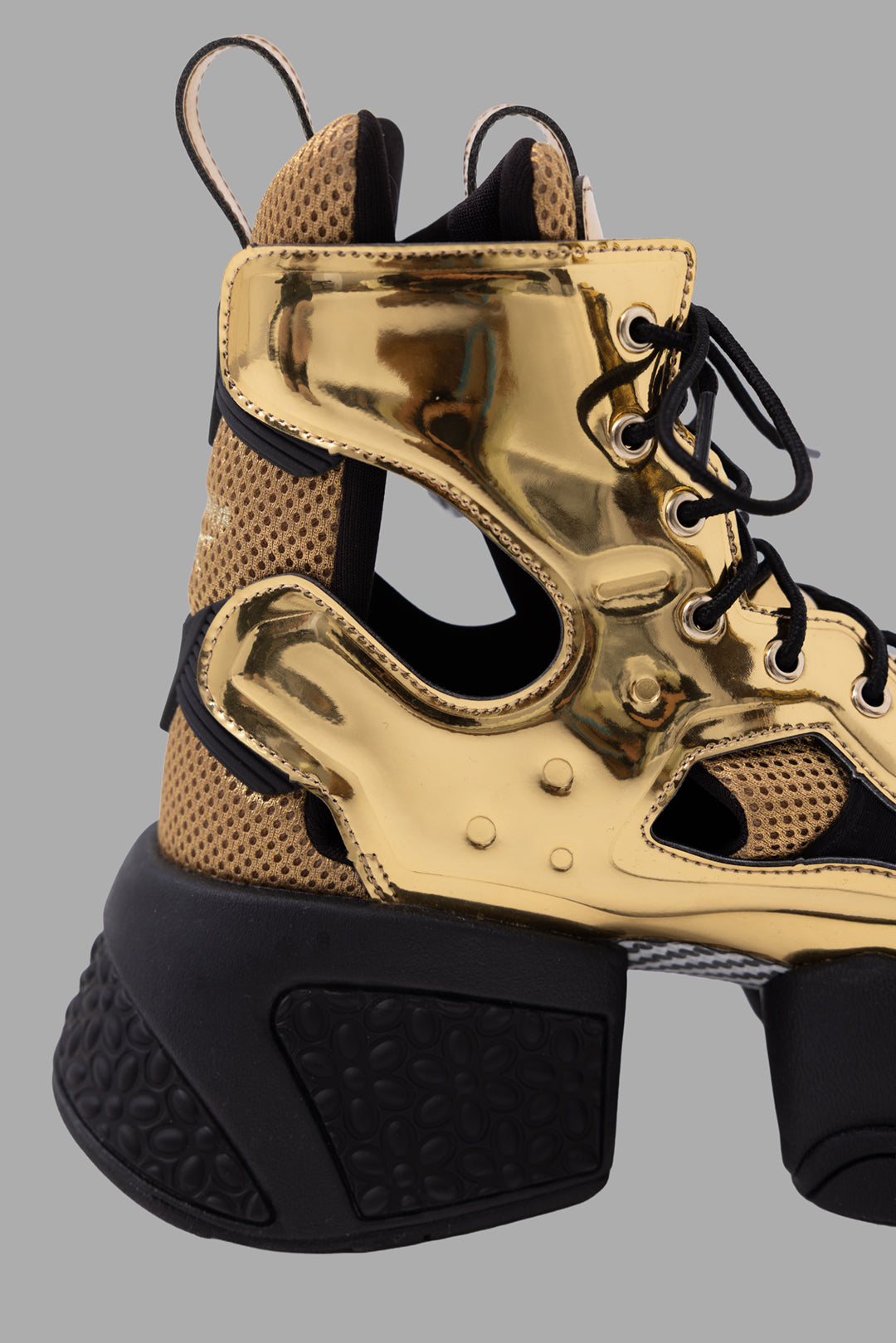 Noir Kei Ninomiya x Reebok unisex gold cutout platform boots, side close-up of metallic cage and perforated mesh