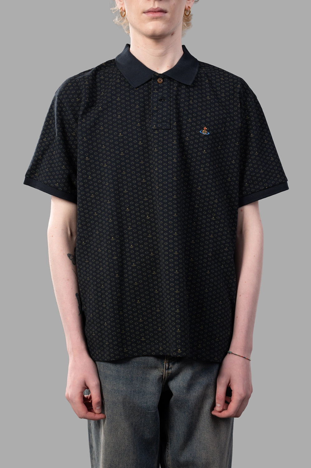 Vivienne Westwood polo shirt in Dots & Orbs, on-model half length, embroidered chest orb and three-button placket