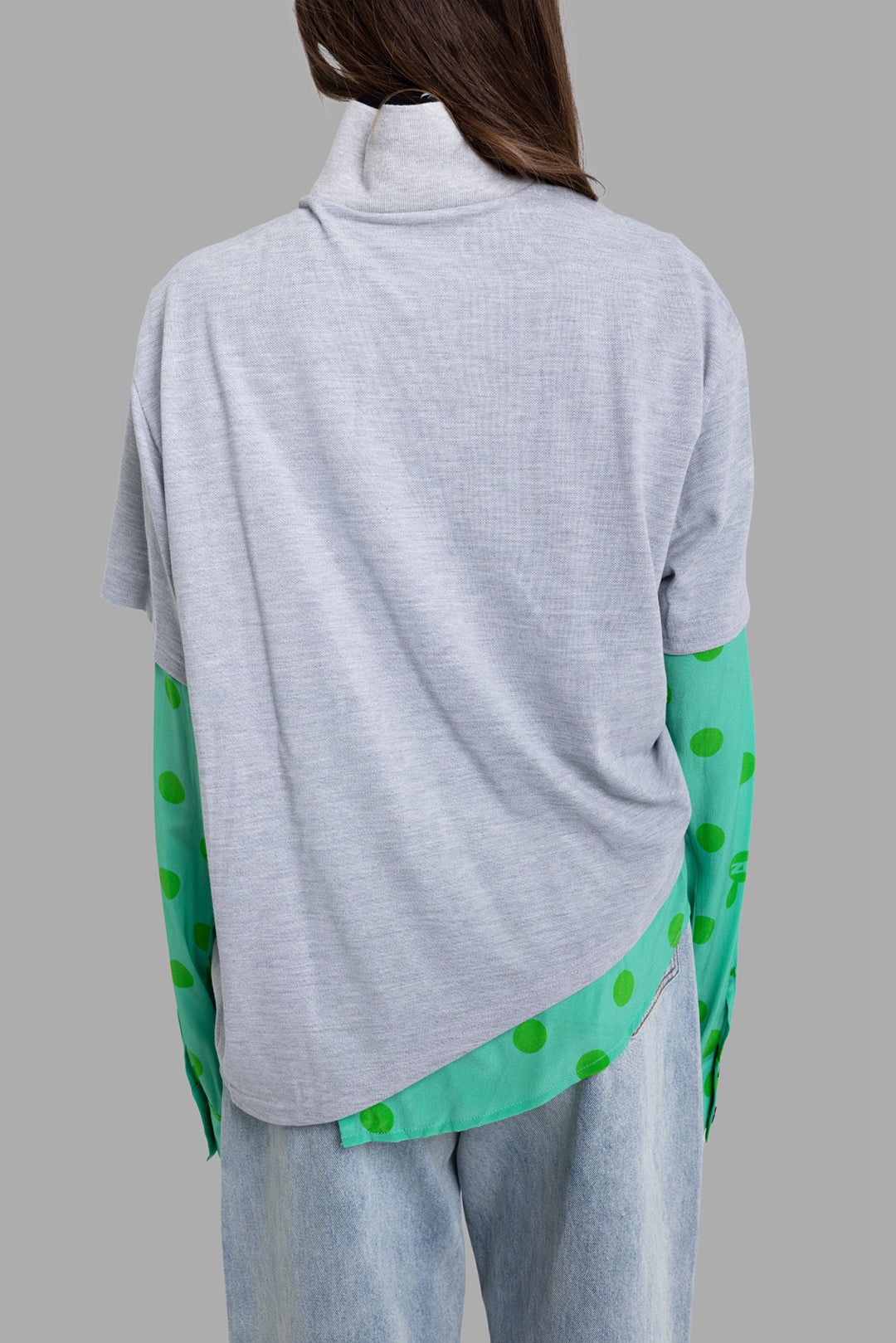 Natasha Zinko women's polka dot polo shirt in grey and green, back view, draped hem and layered polka-dot panel peeking below