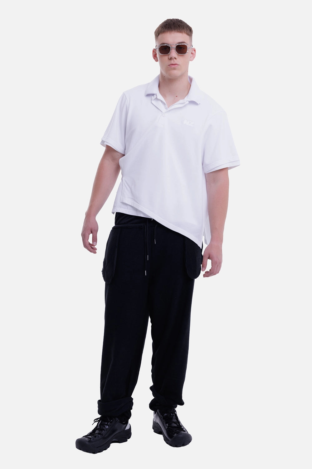 Natasha Zinko men's white polo shirt, full-length model view with asymmetric layered hem