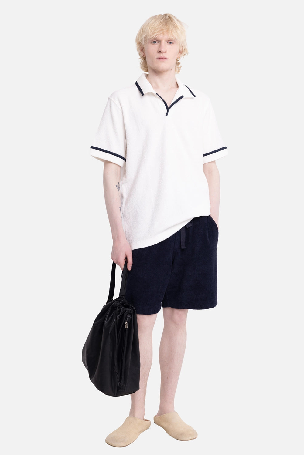 Orlebar Brown men's polo shirt in White Sand/Night Iris, on-model full-length, navy trim and open collar