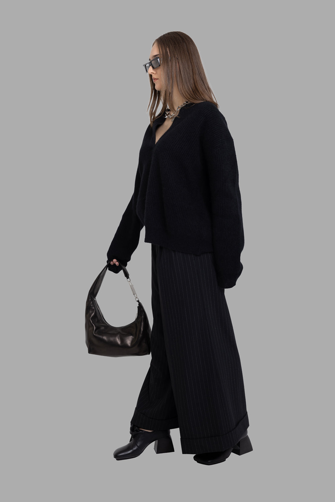 Uma Wang women's black raccoon polo sweater, side on-model full length, V-neck polo collar and relaxed oversized fit