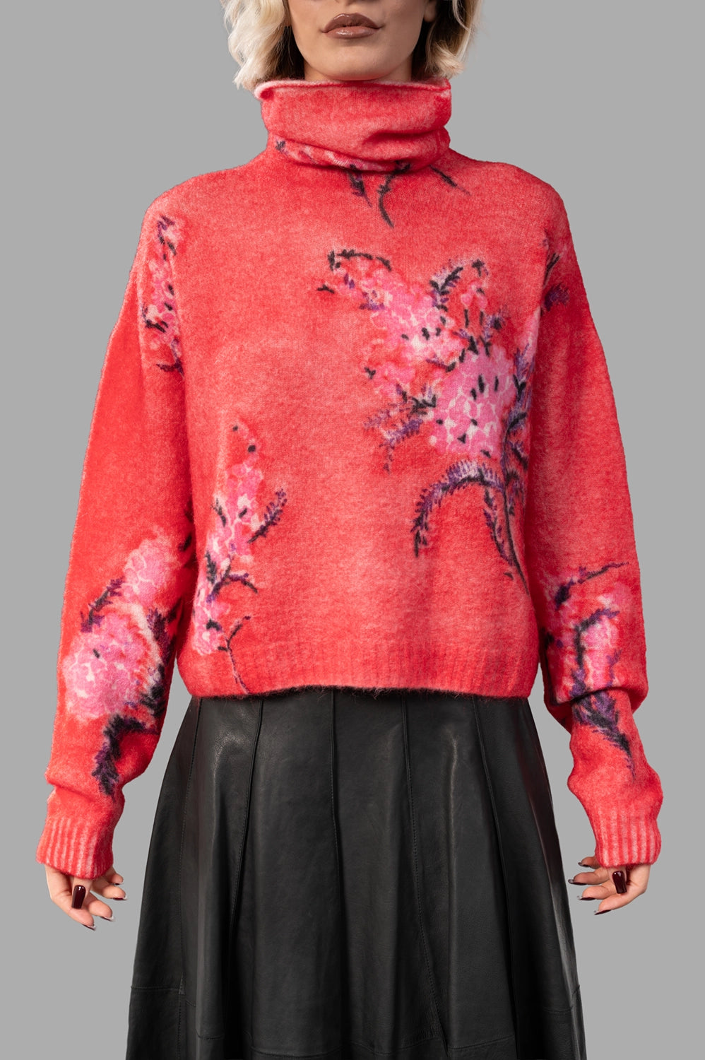 front close-up of rubis/rose turtleneck pullover with handpainted floral motif and soft knit texture