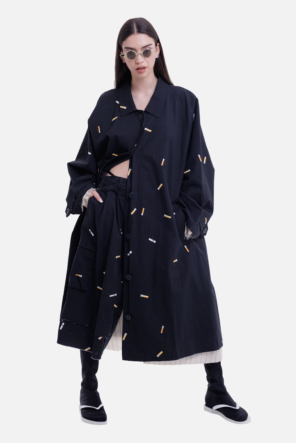 Natasha Zinko women's black raincoat, model view with cigarette print and striped underlayer