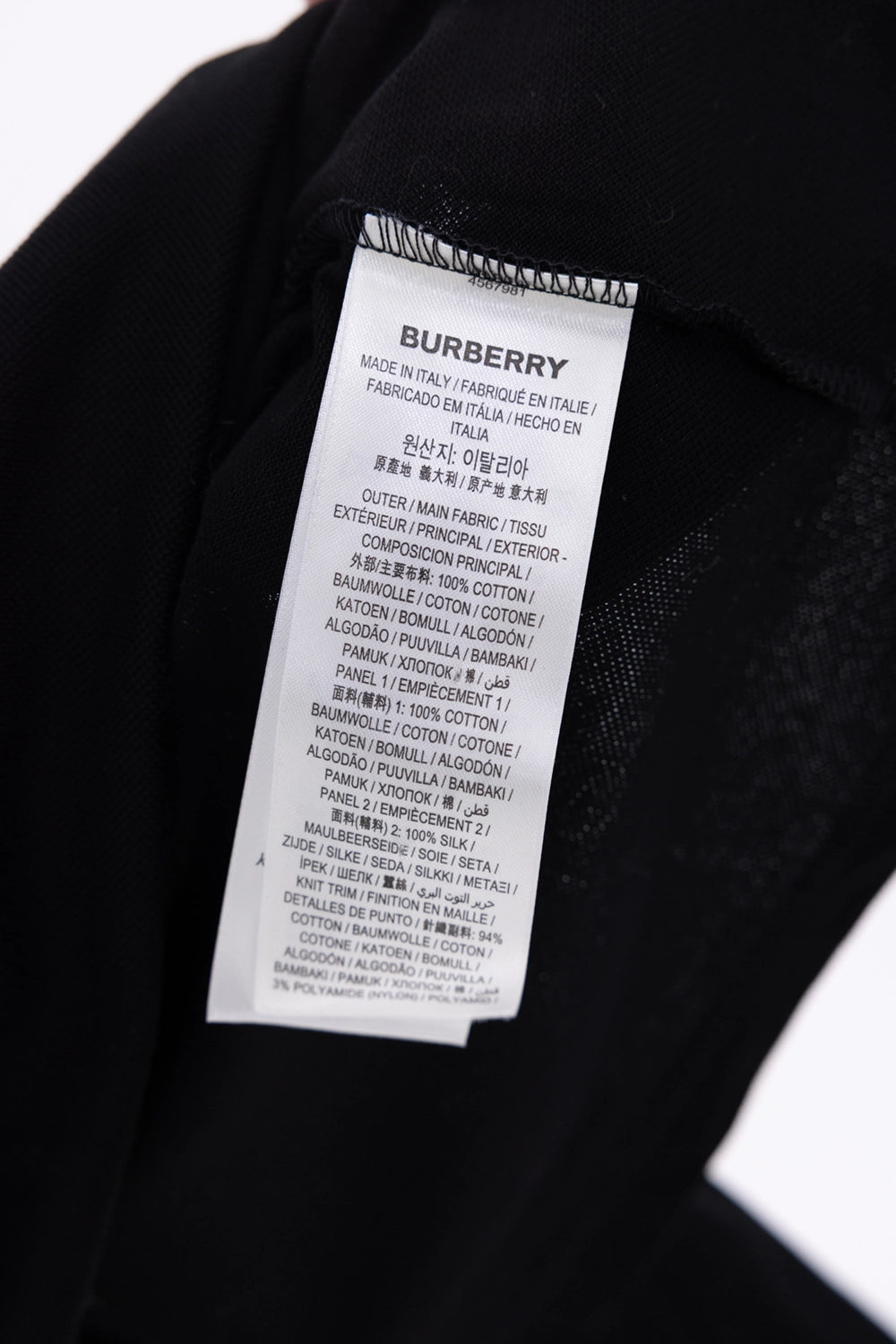 Pre-owned Burberry reconstructed polo shirt in black, composition label close-up, cotton and silk listed